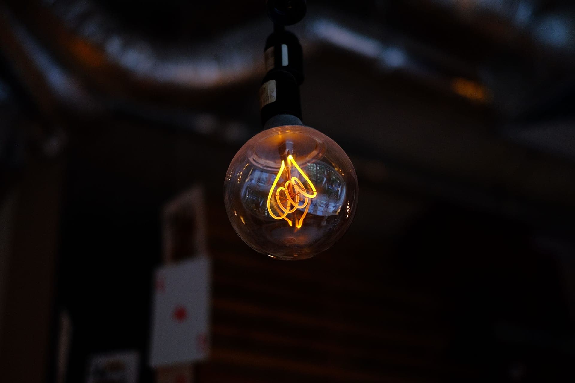 A warm glowing filament bulb, illustrating an overhead basking lamp