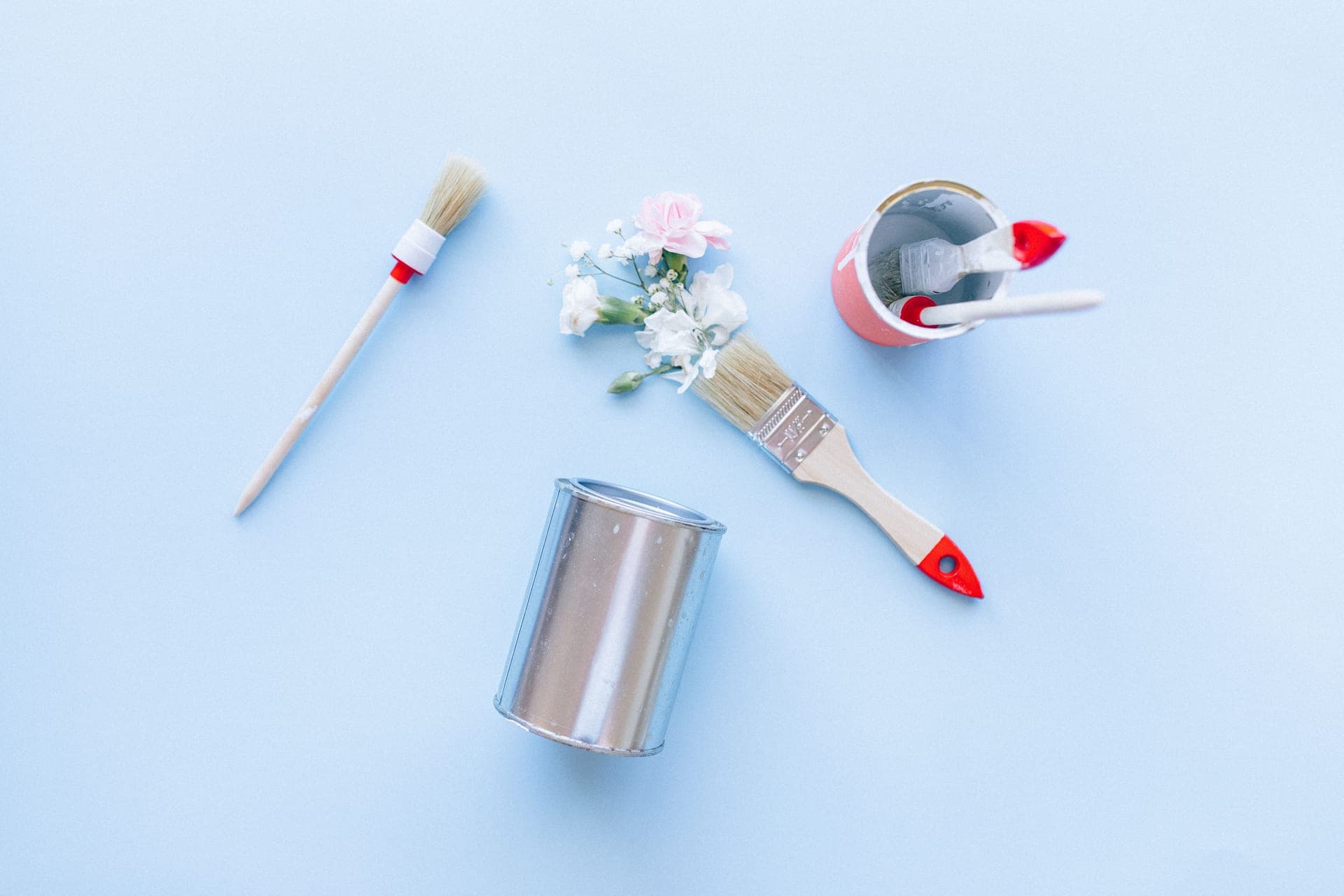 Paint brushes and cans on a surface