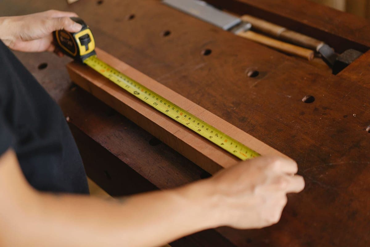 A ruler and measuring tape on a workbench